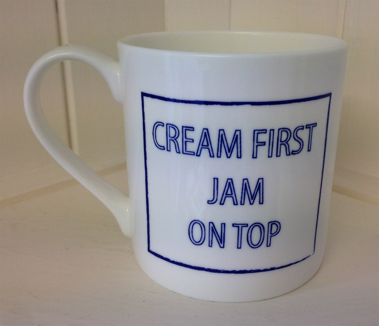 Mug printed with the slogan Cream first, jam on top