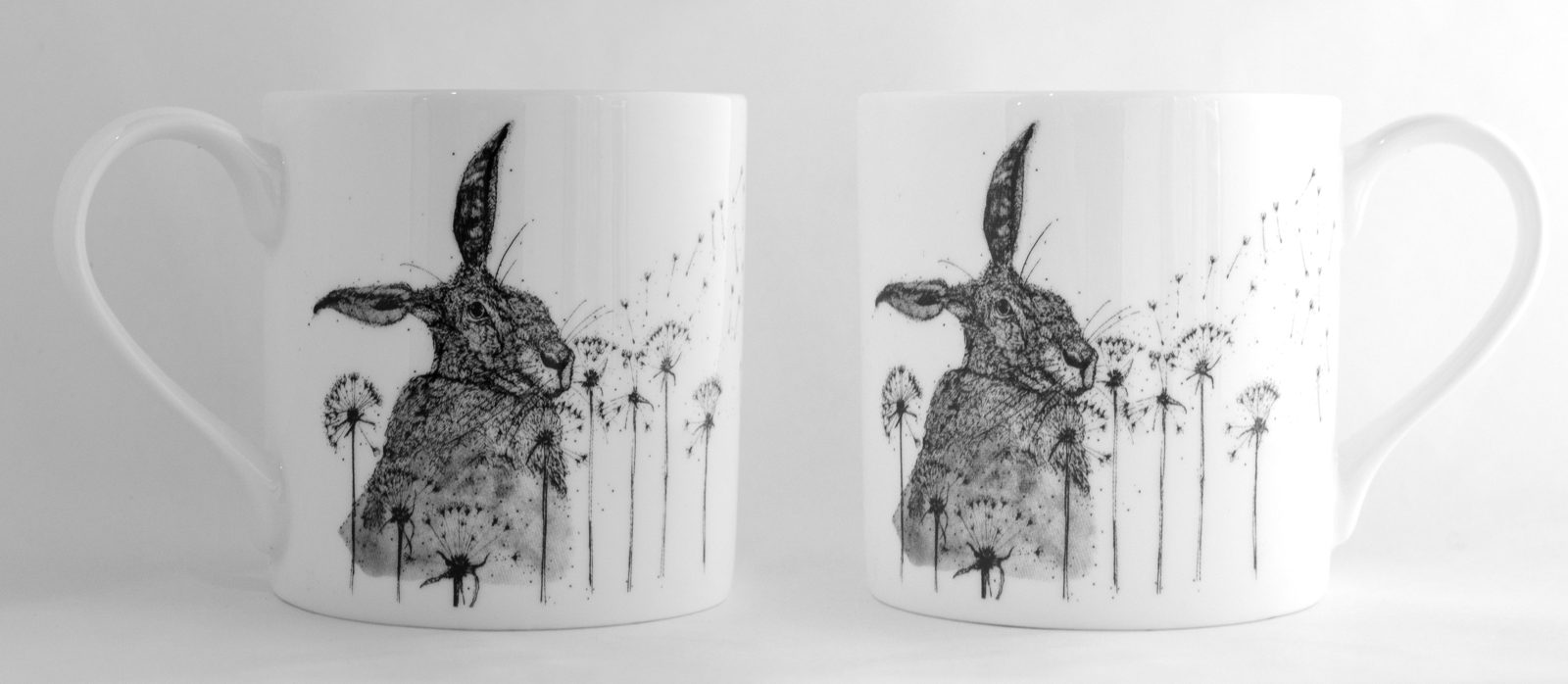 Pair of mugs with a hare among dandelion clocks