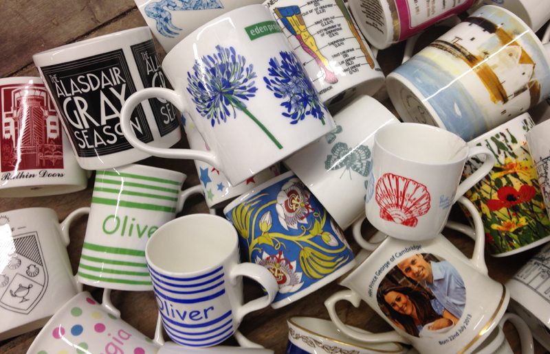 A heap of printed mugs in many different designs