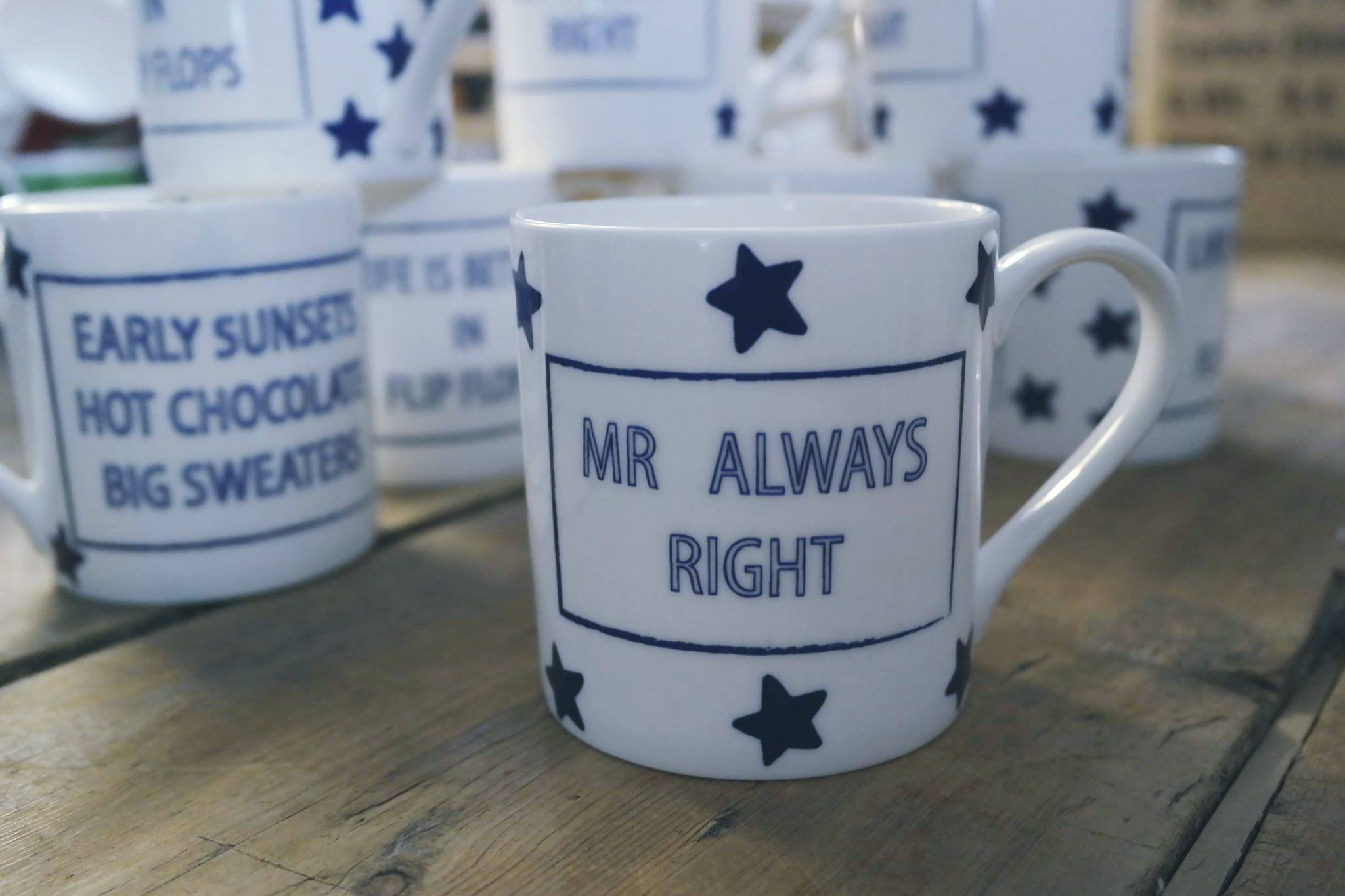 Display of slogan mugs with blue lettering and stars