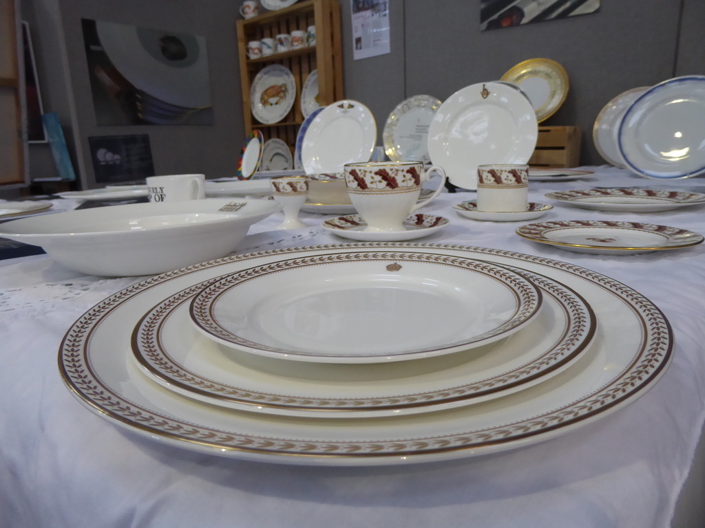 Table set with gold-rimmed plates, cups and saucers