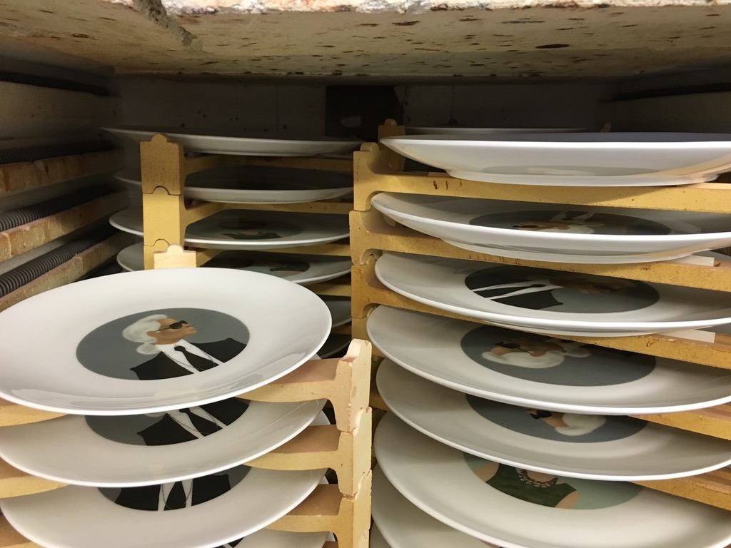 Printed plates stacked in racks ready for the kiln